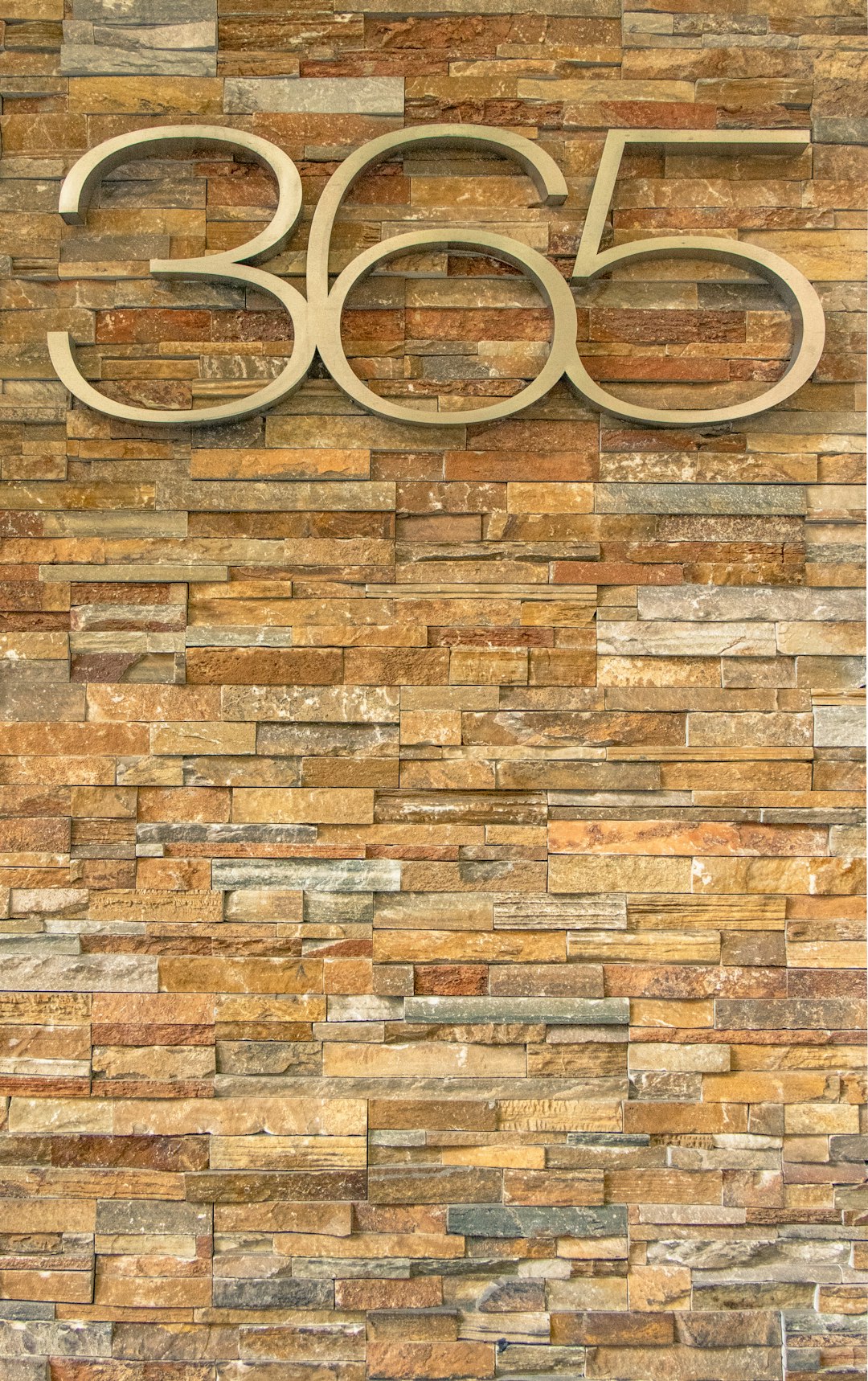 Photo by Mitchell Luo 365 cutout number on brick wall